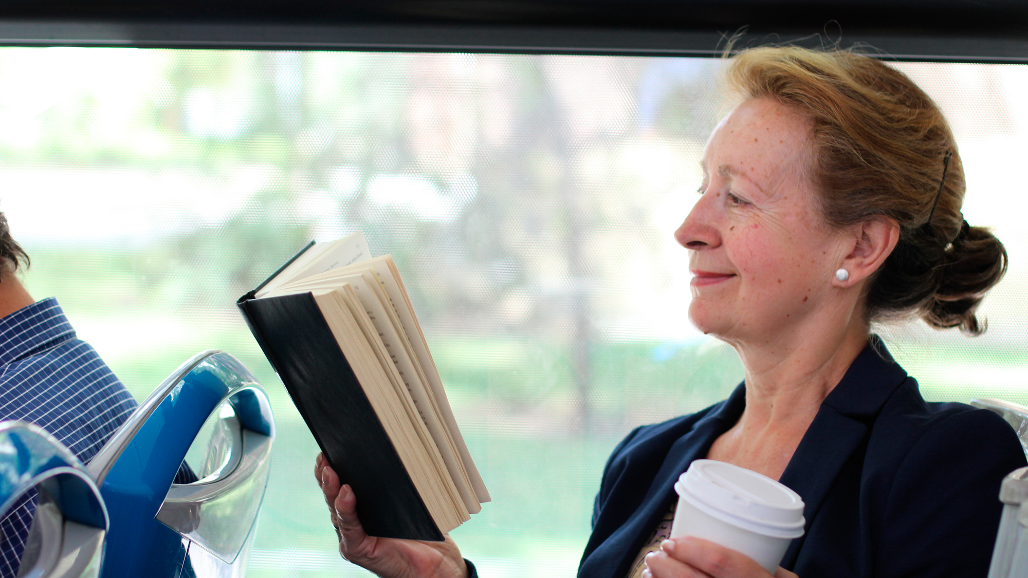 woman smiling and reading