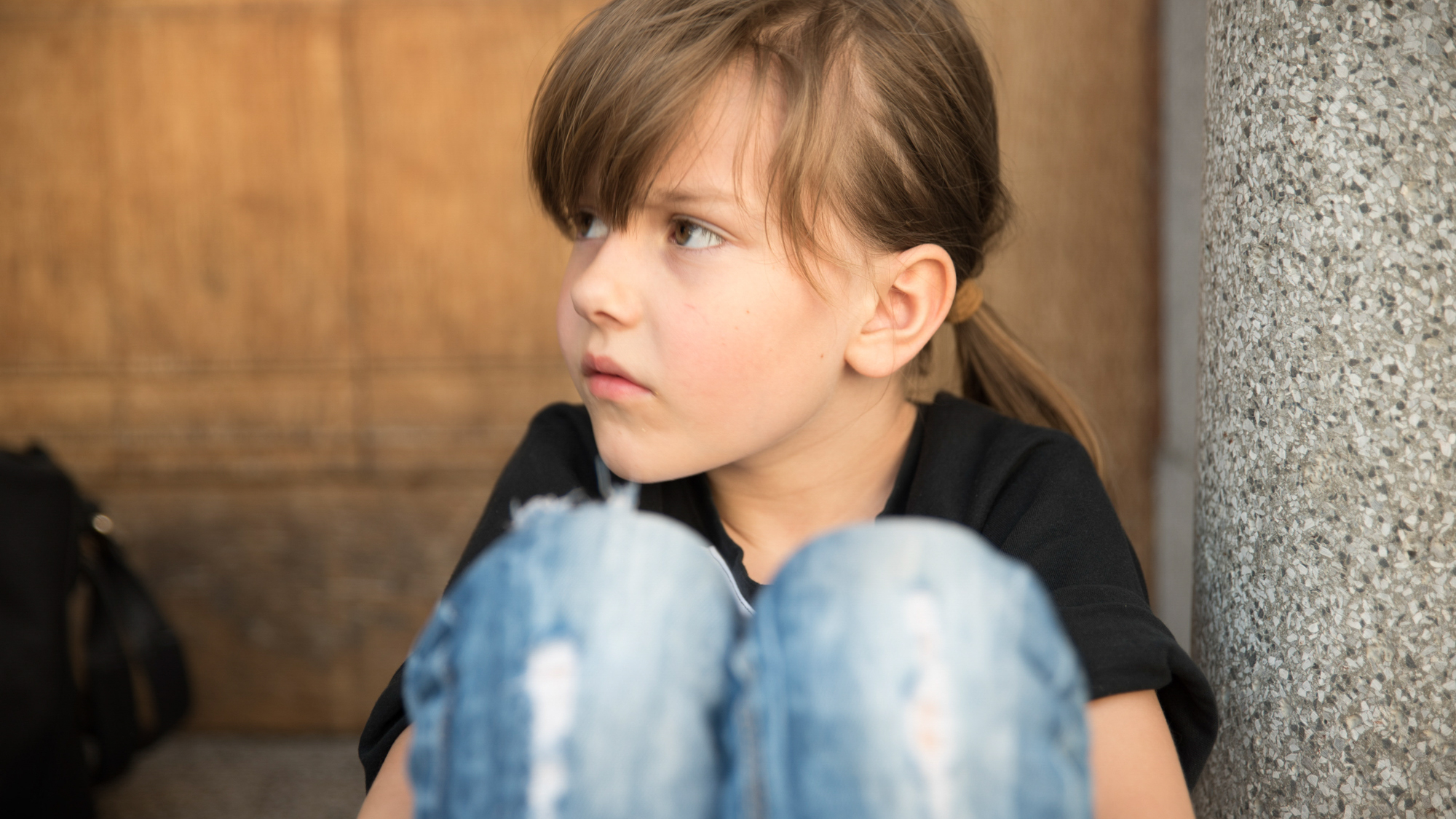 young girl looking over her knees