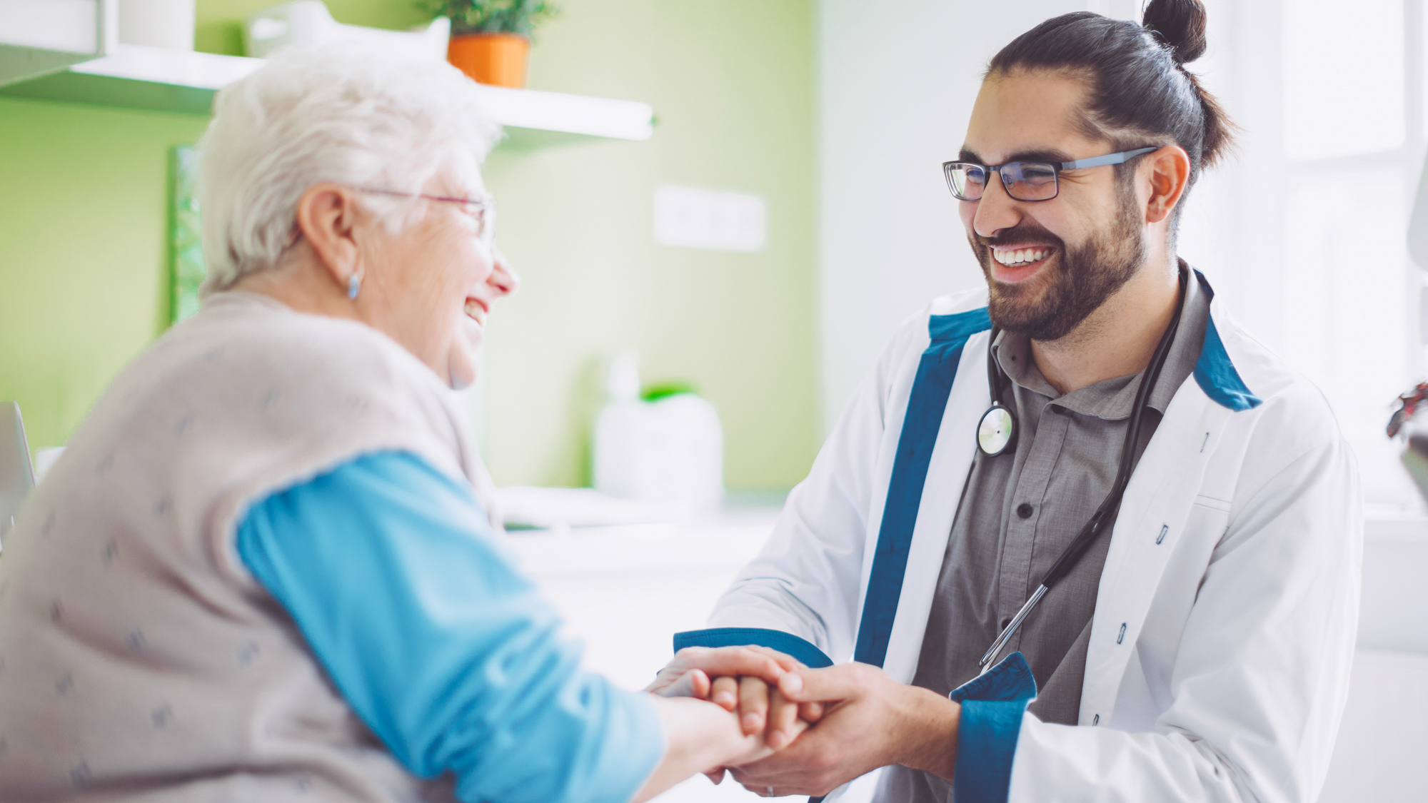 two people talking in a clinical setting and smiling