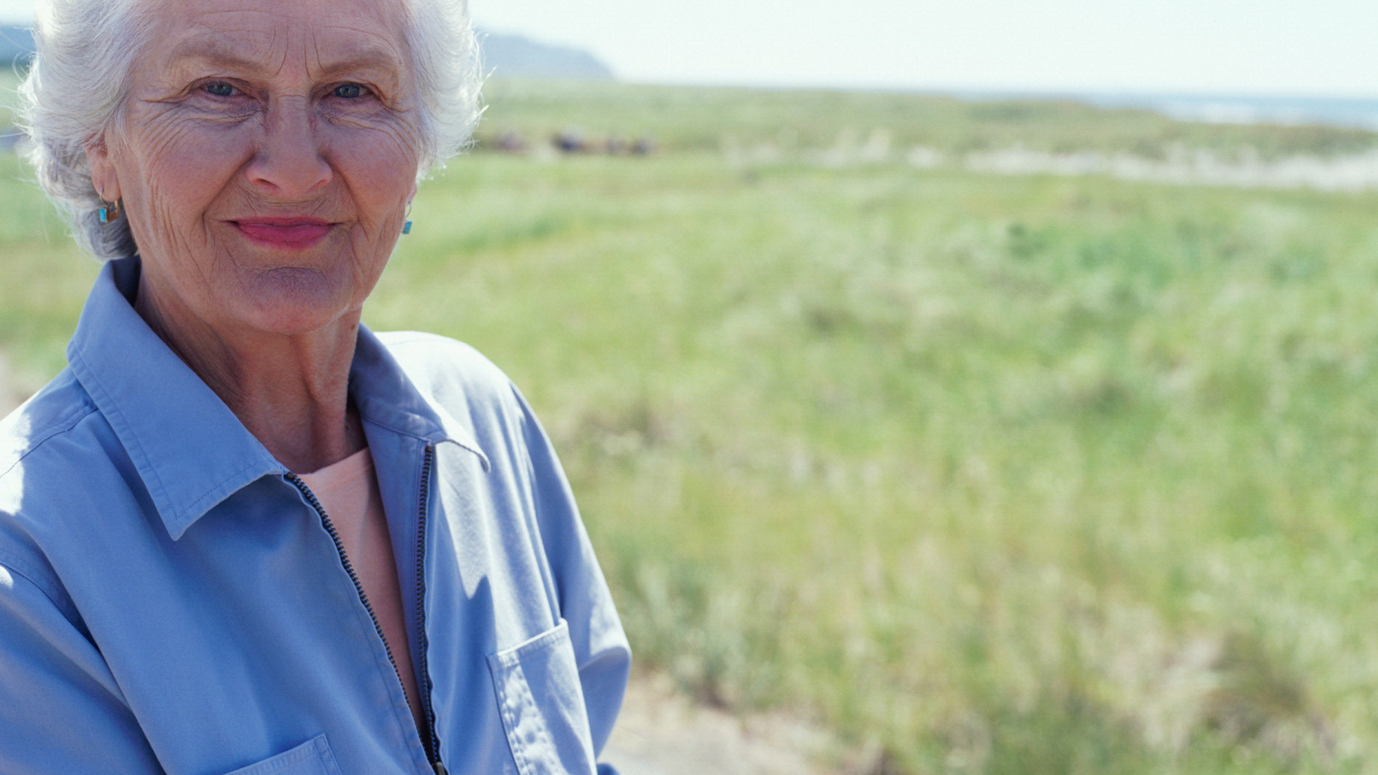 Elderly woman in sunny field