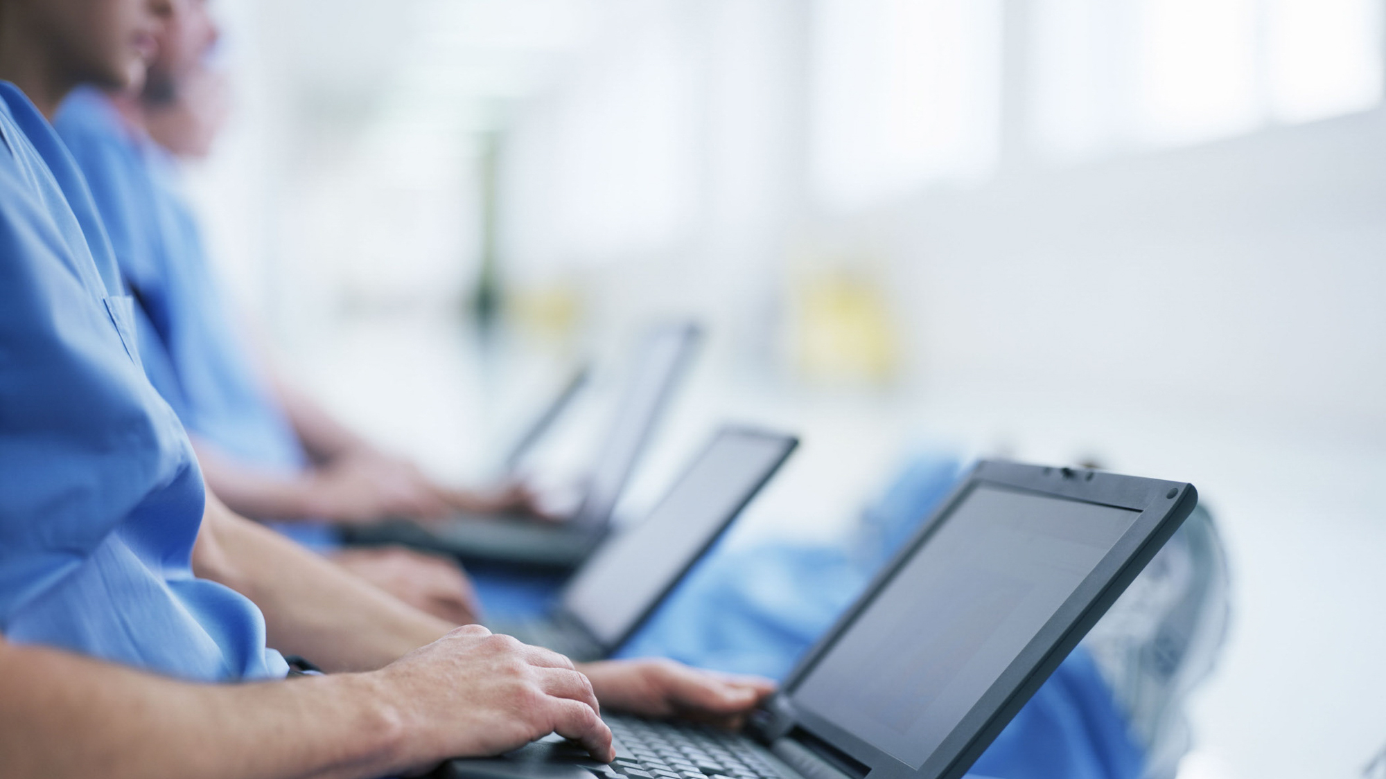 clinicians working on laptops