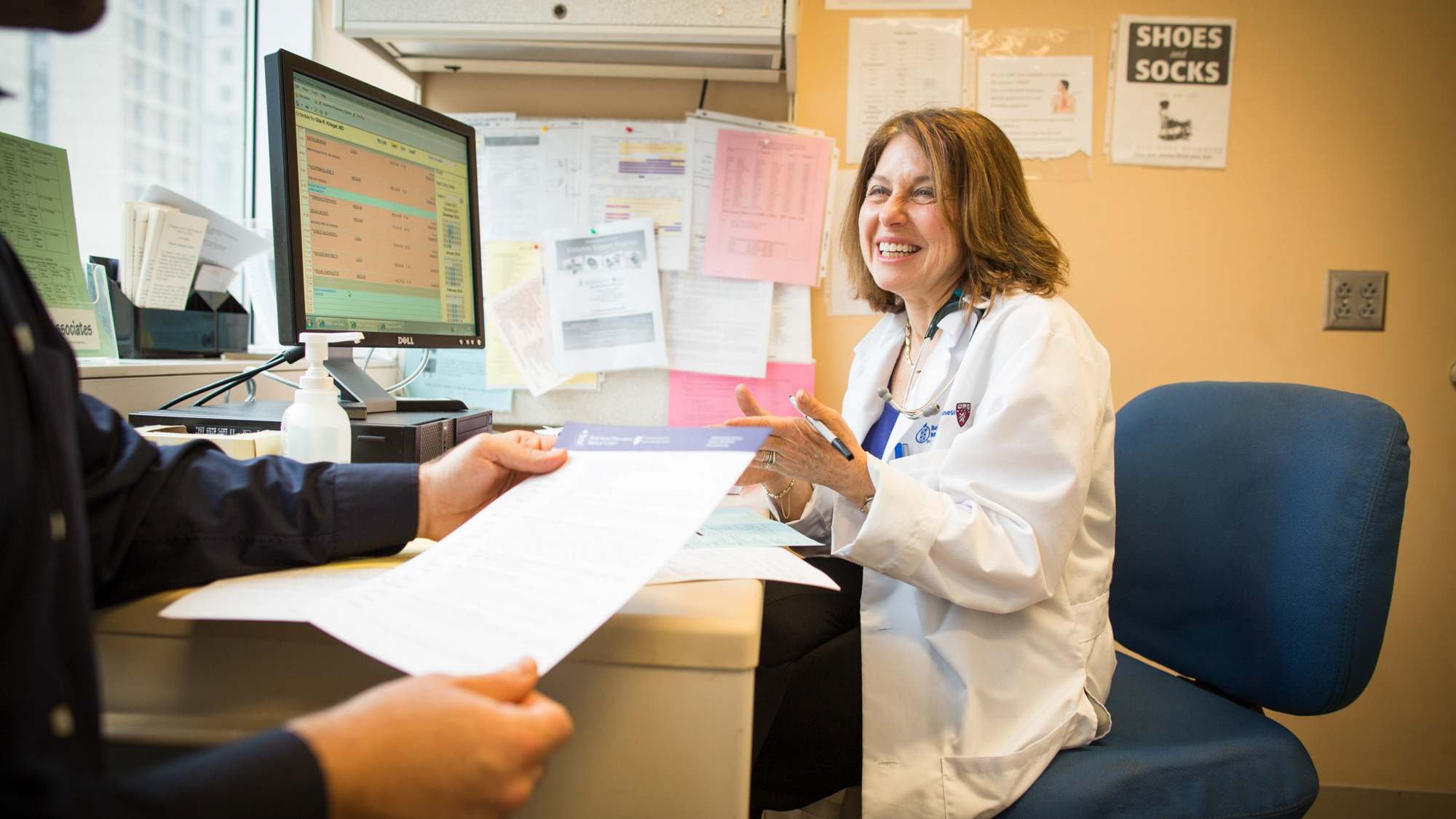 female clinician talking cheerfully with patient