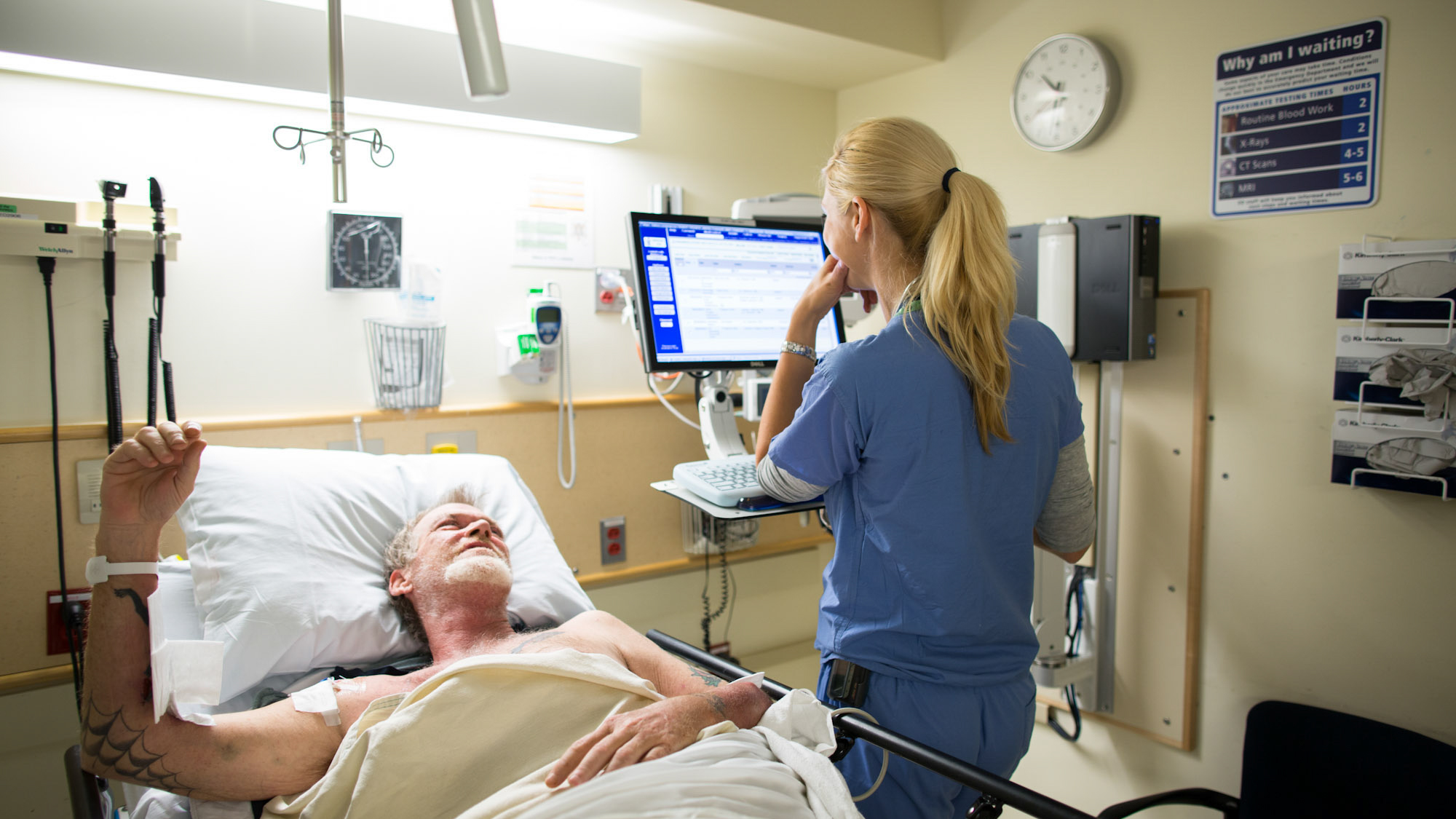 female clinician visiting male patient in bed