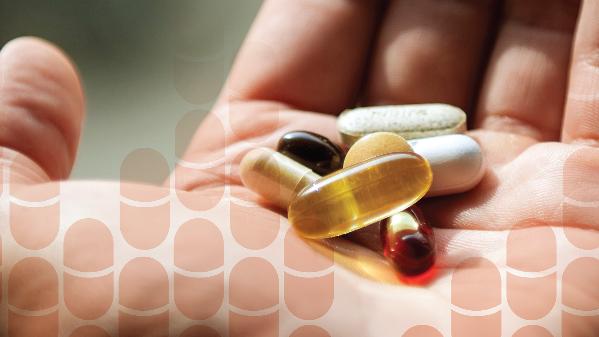 close up of a hand holding assorted pills