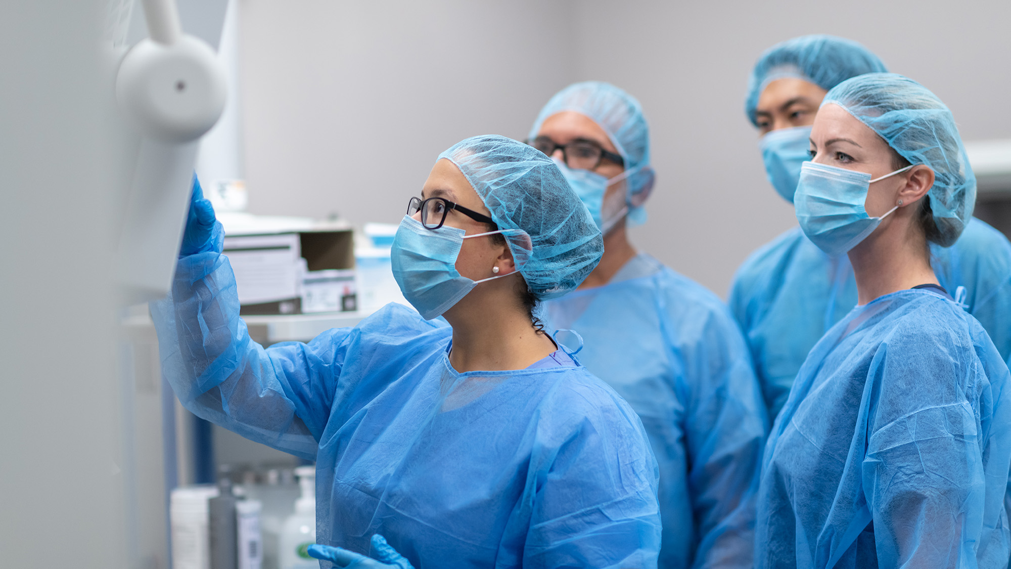 surgeons in OR checking a computer screen