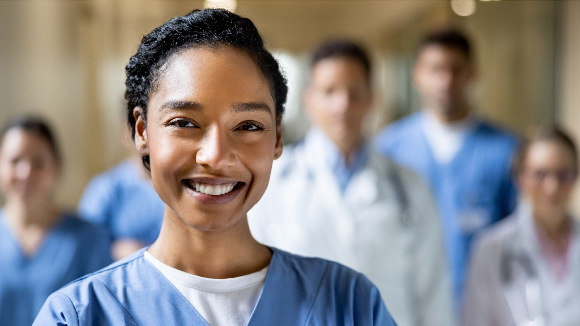 Smiling nurse in blue scrubs