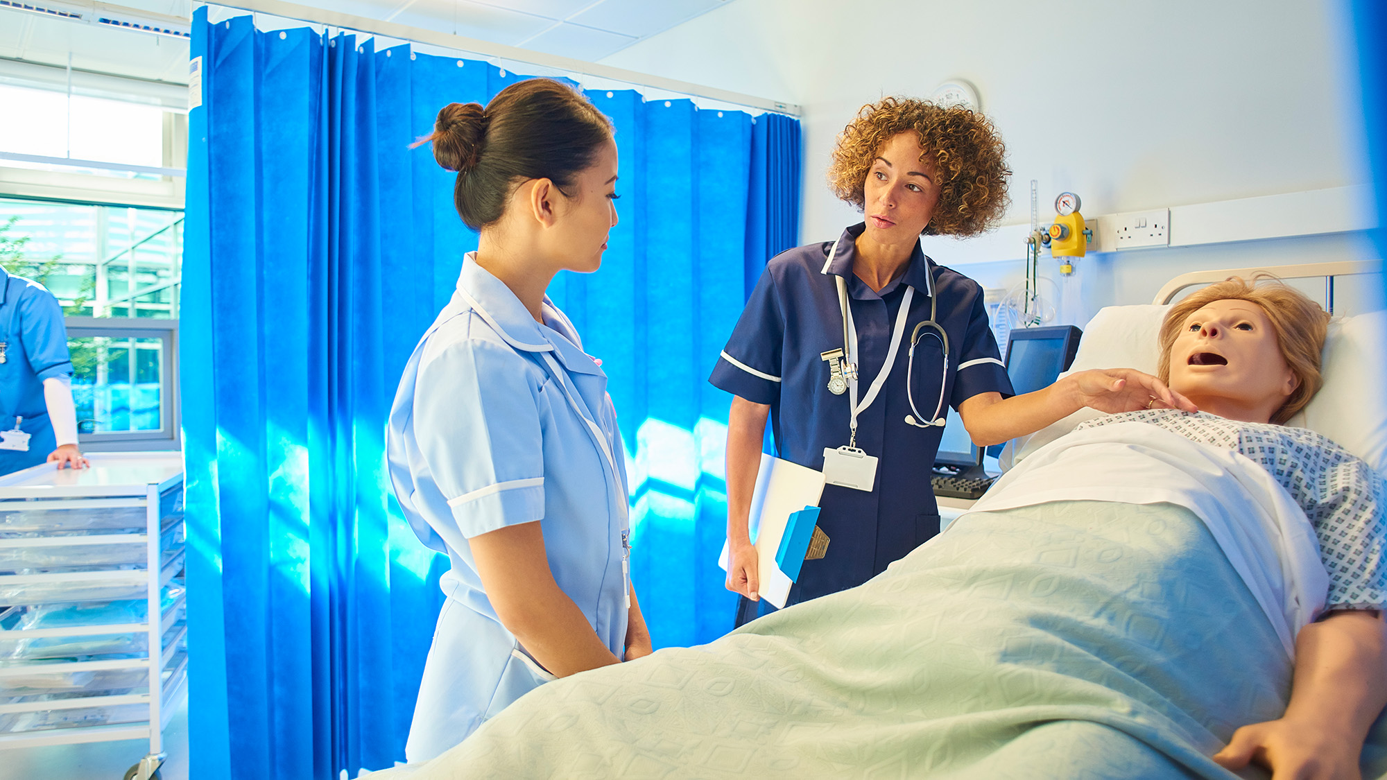 clinicians next to a medical simulation manikin