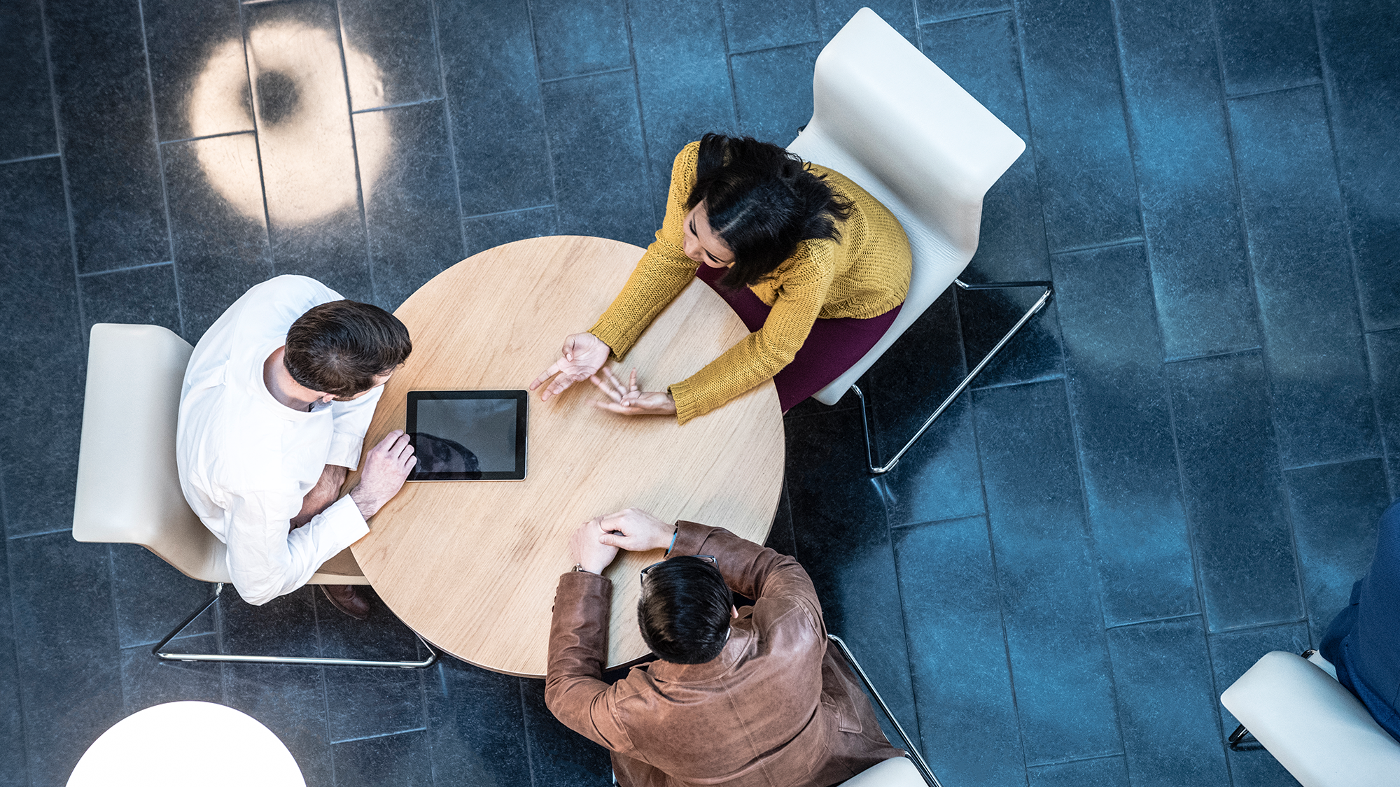 Rapid Pulse update image of three people around a table colloborating