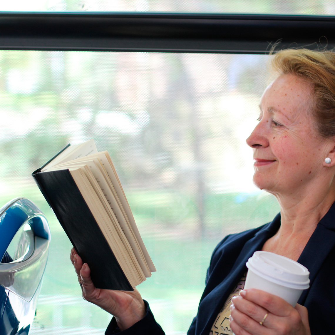 woman smiling and reading