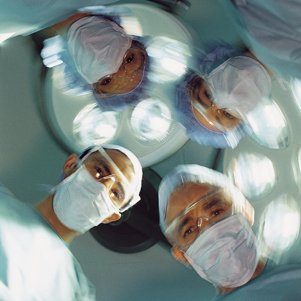 view of surgeon faces from patient on table