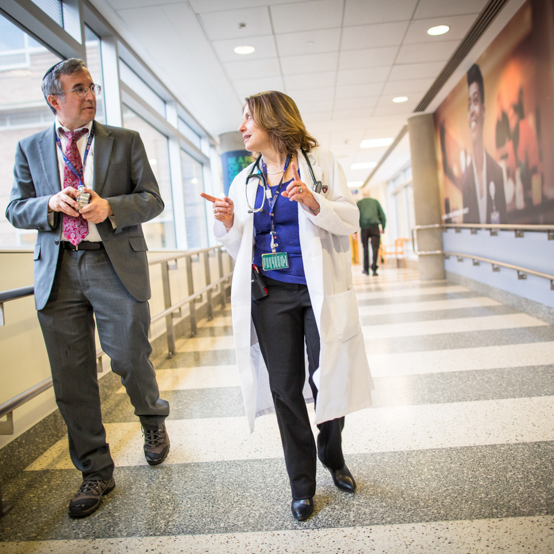 man and woman discussing something in a hallway