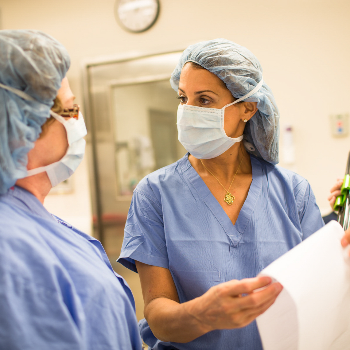 female surgeons confer over readout