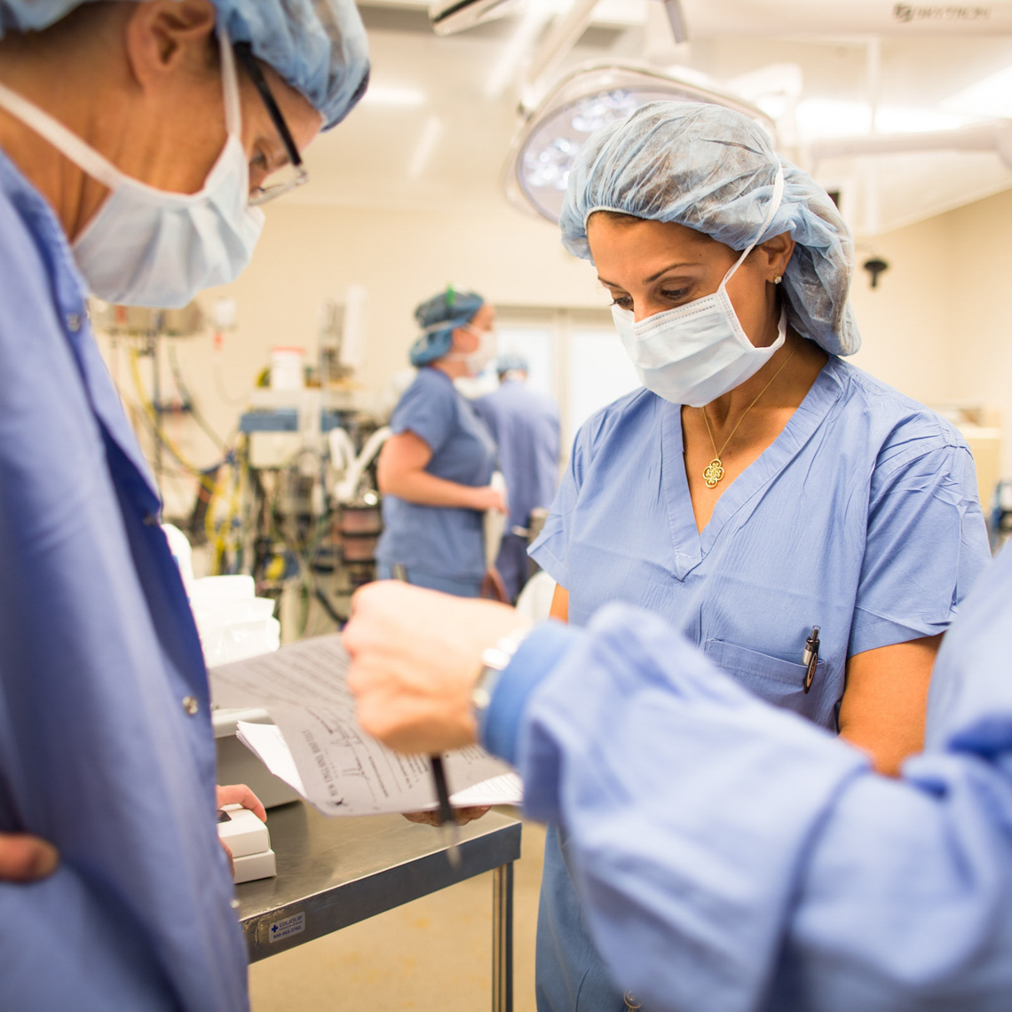 female surgeons assess a finding