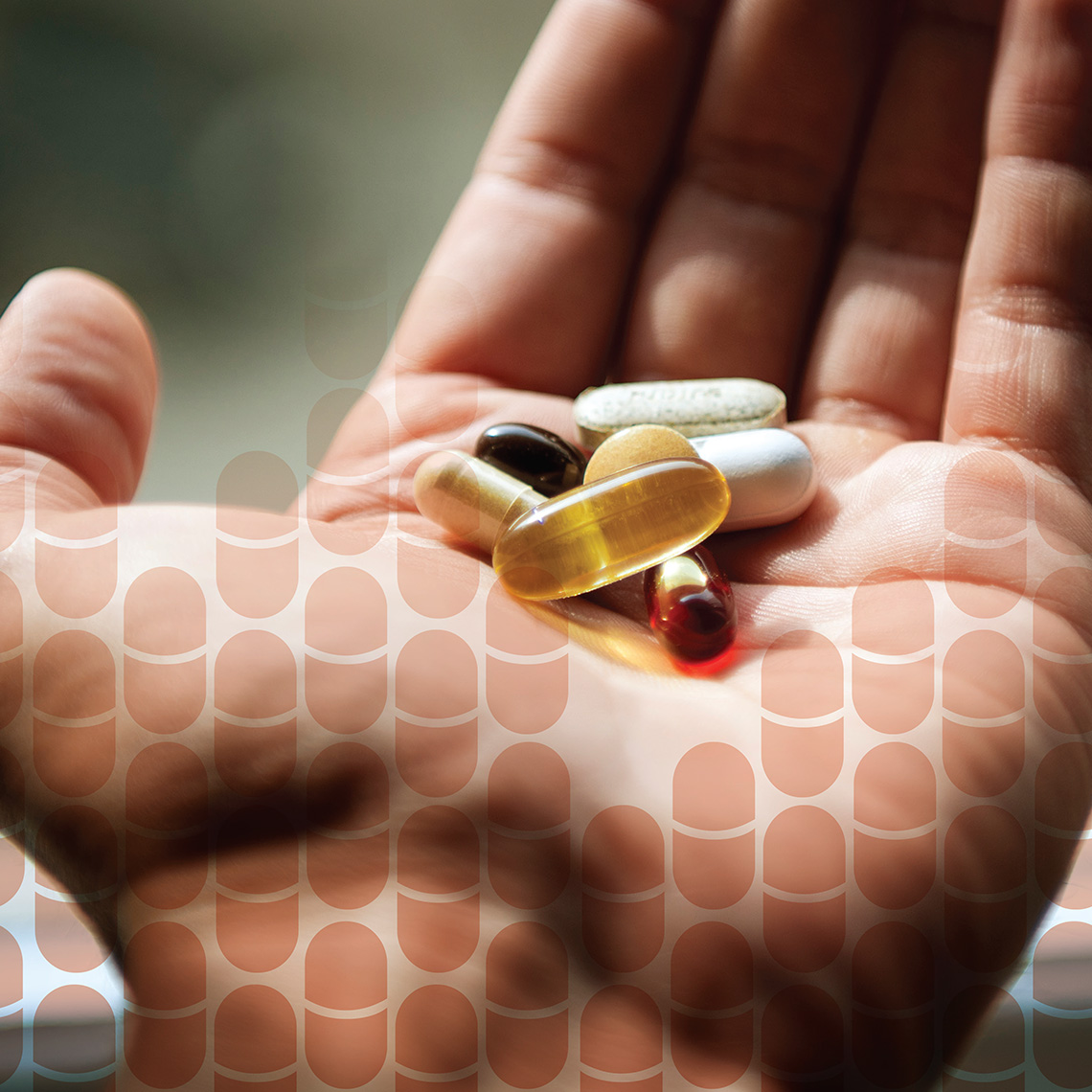 closeup of a hand holding an assortment of pills