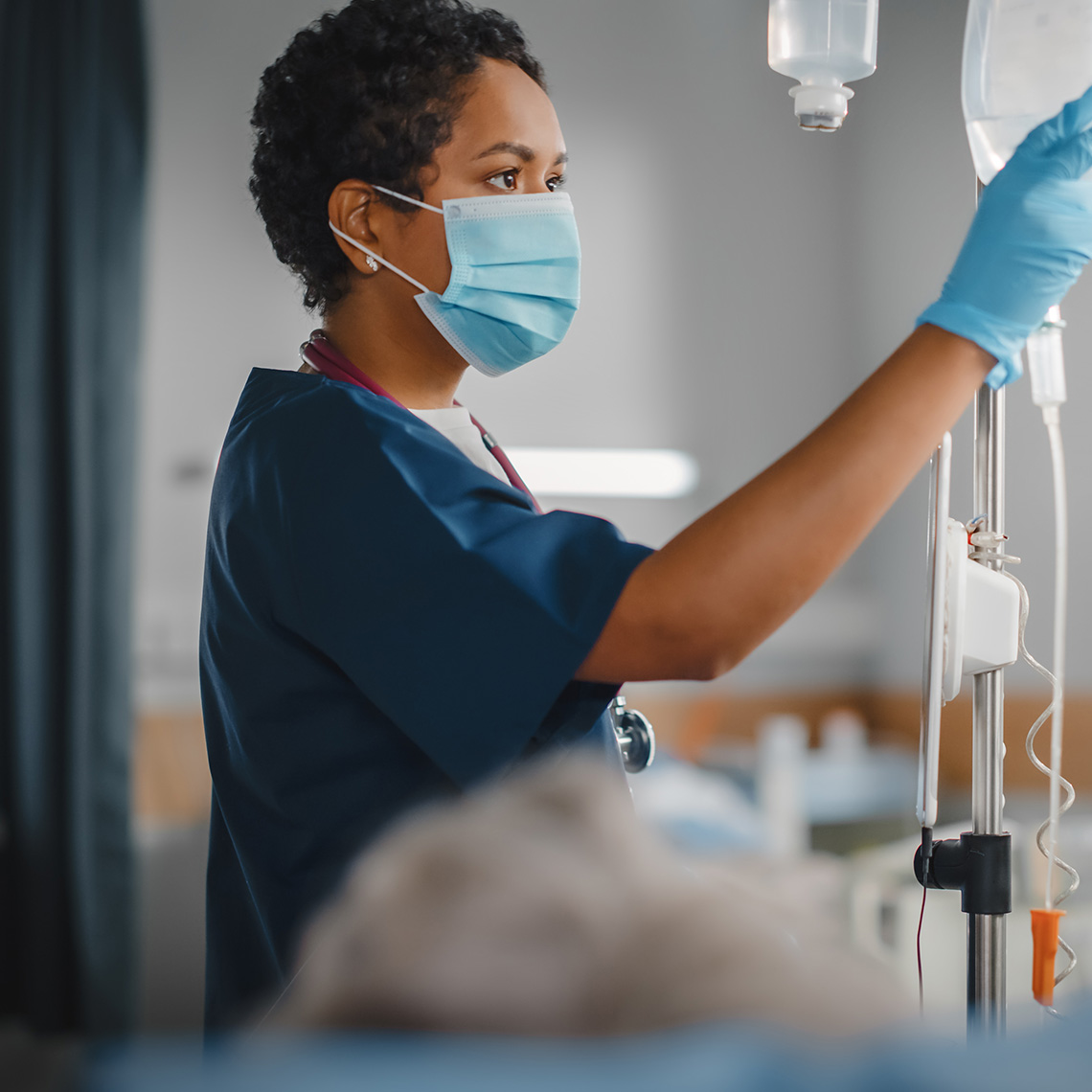 nurse adjusting an IV