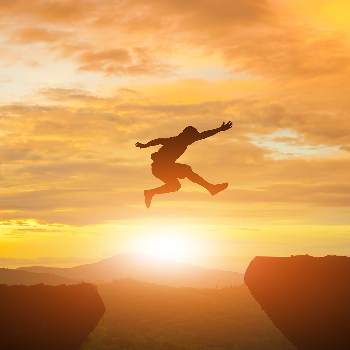 person leaping over a chasm