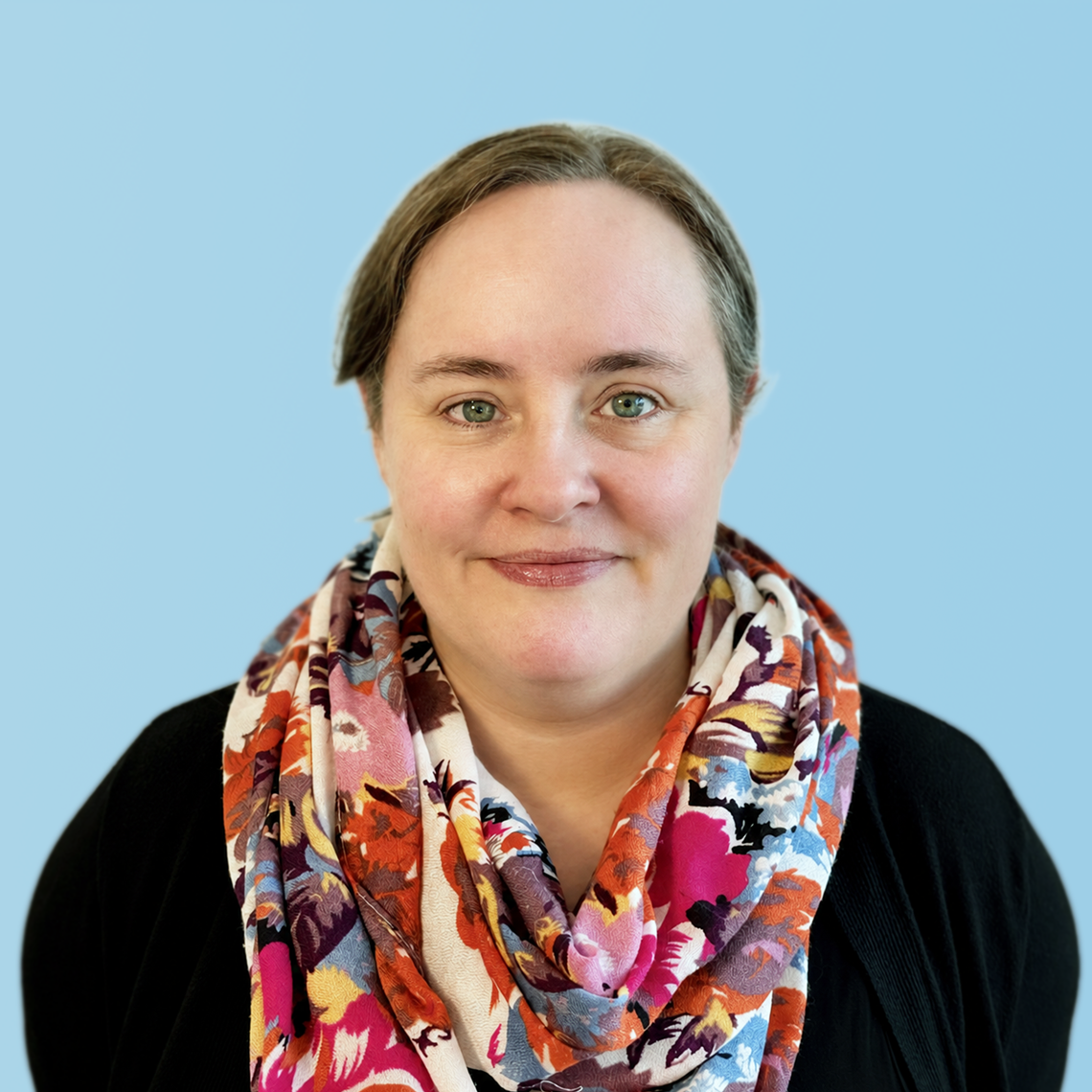 Upper body and face of Amanda Carruth who is wearing a colorful scarf