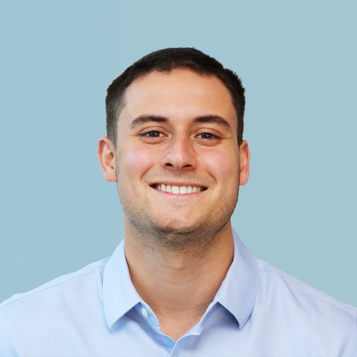 Headshot of Maxwell Boye in a blue collared shirt