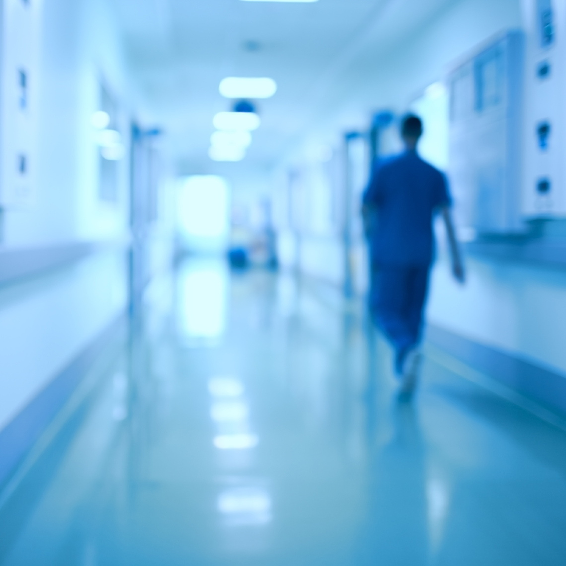 clinician alone in a hospital hallway