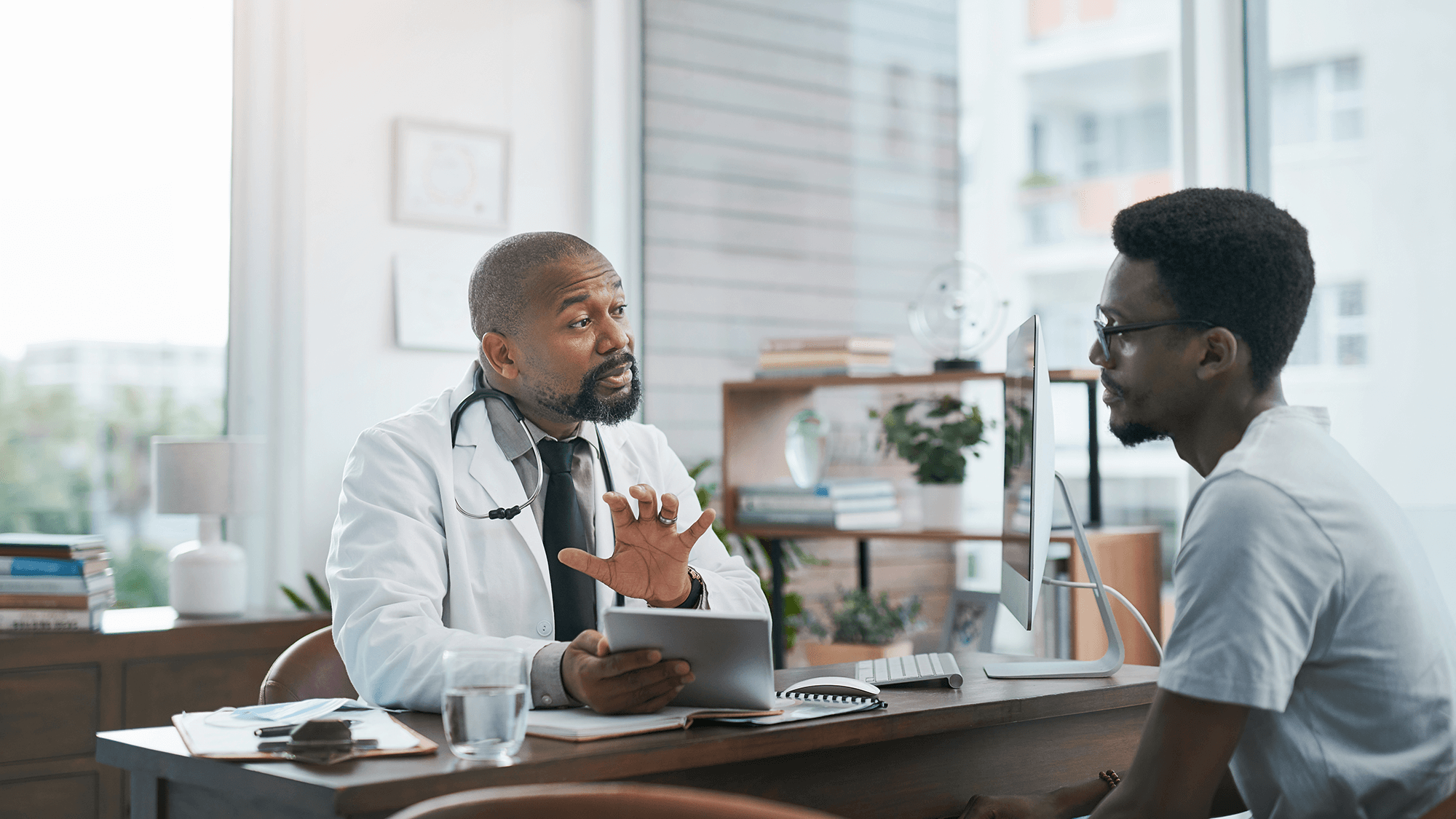 a physician and patient having a conversation in an office