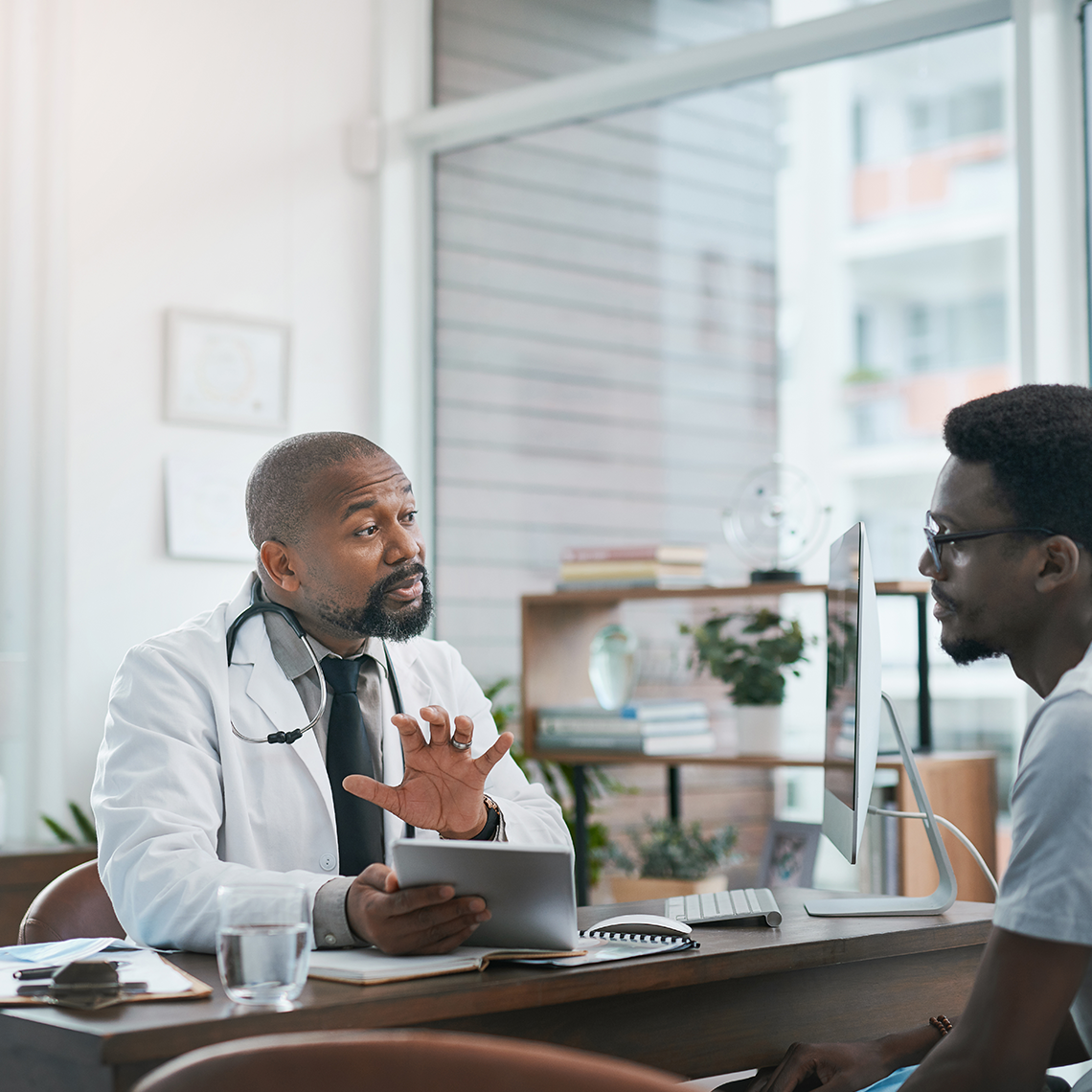 a physician and patient having a conversation in an office