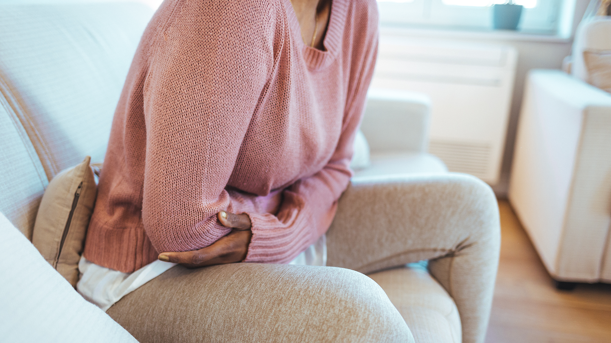 woman holding her abdomen