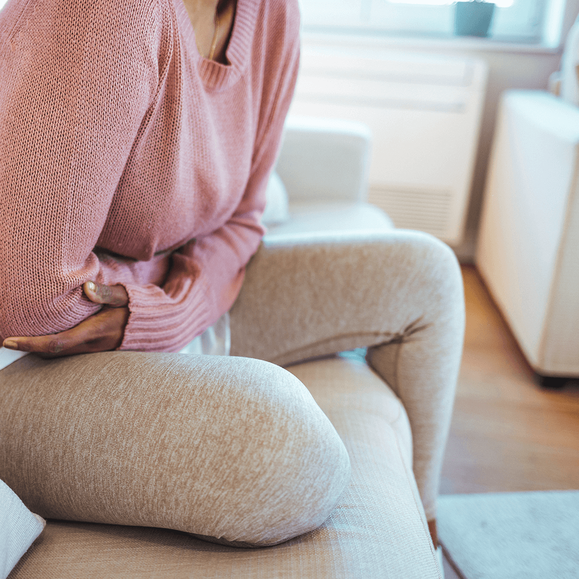 woman holding her abdomen