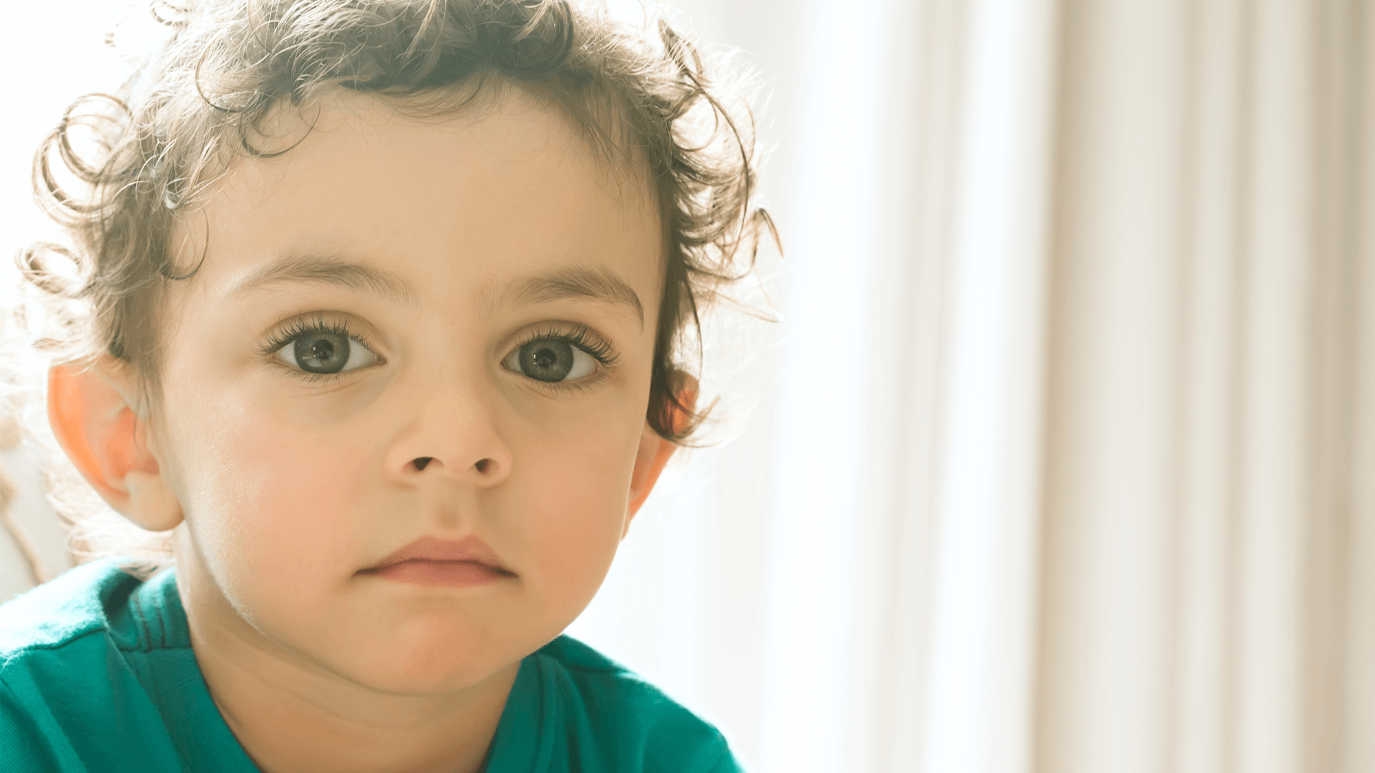 young child looking at viewer