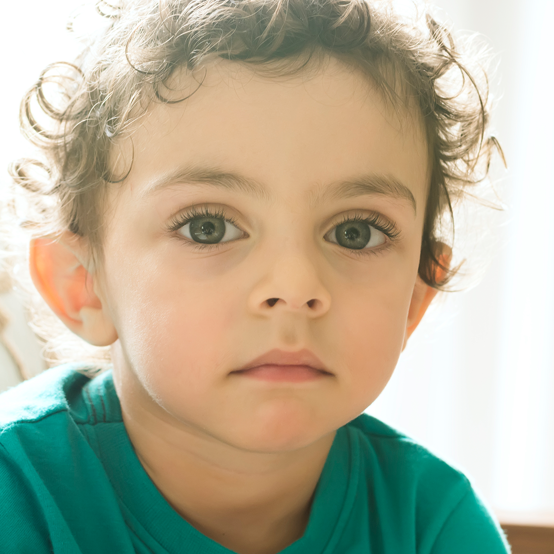 young child looking at viewer