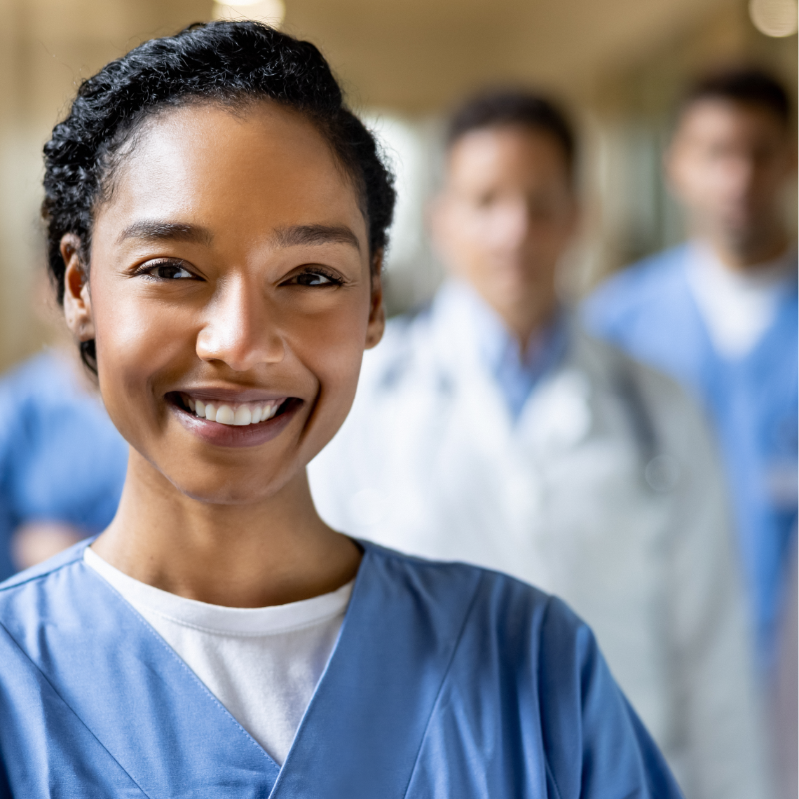 Smiling nurse in blue scrubs