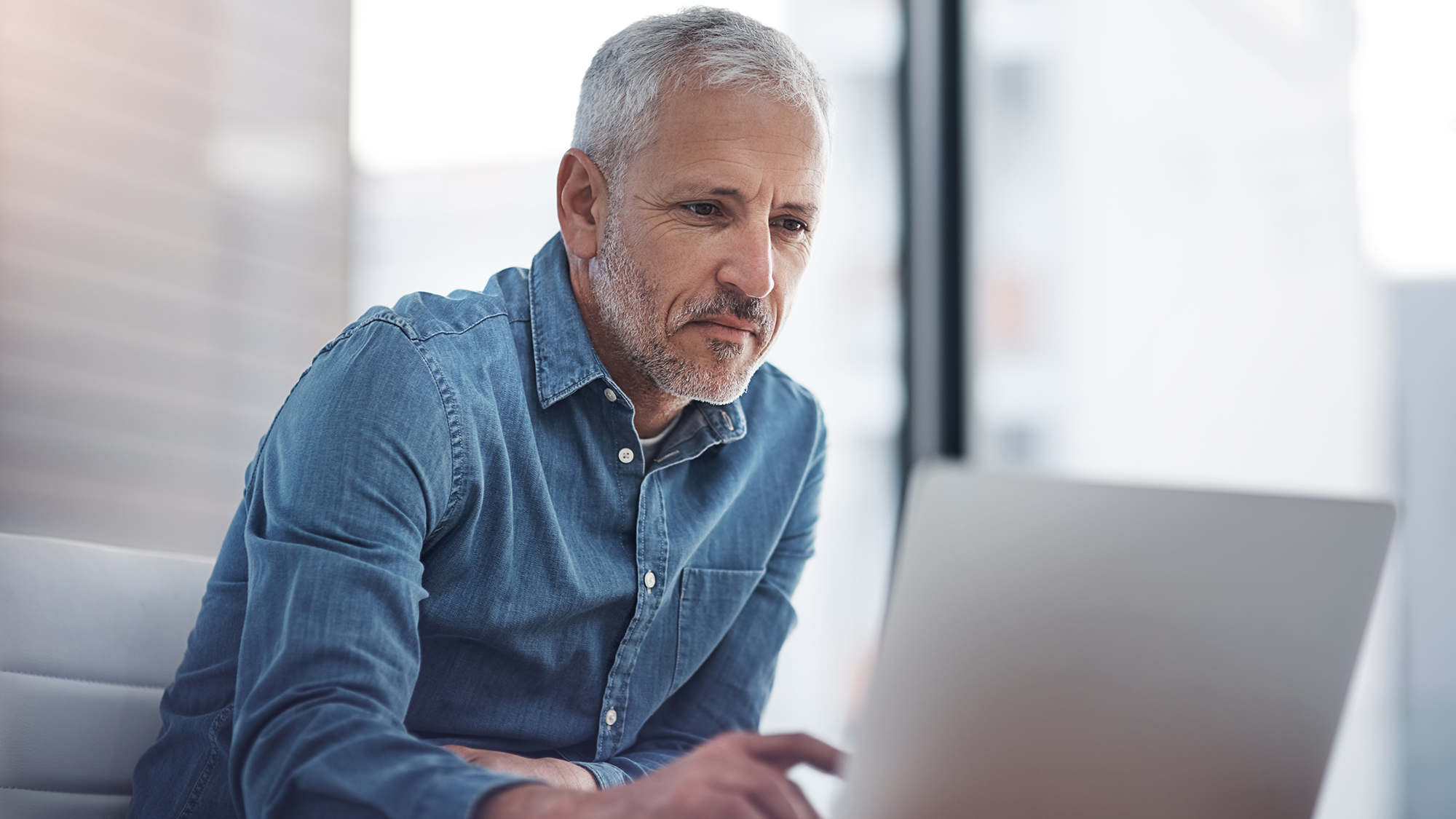 older man using computer