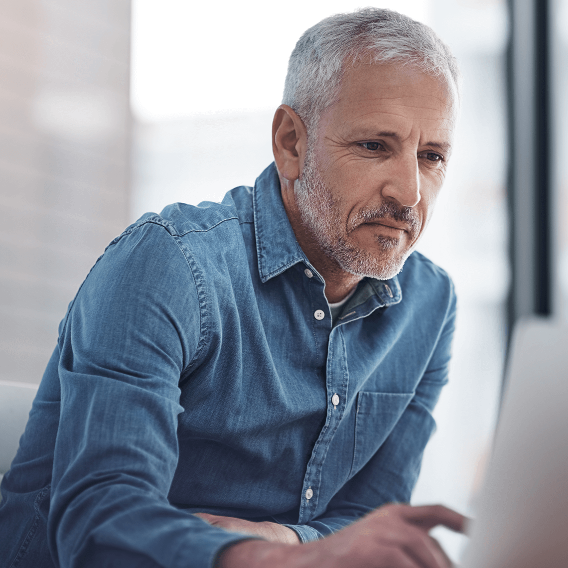 older man using computer