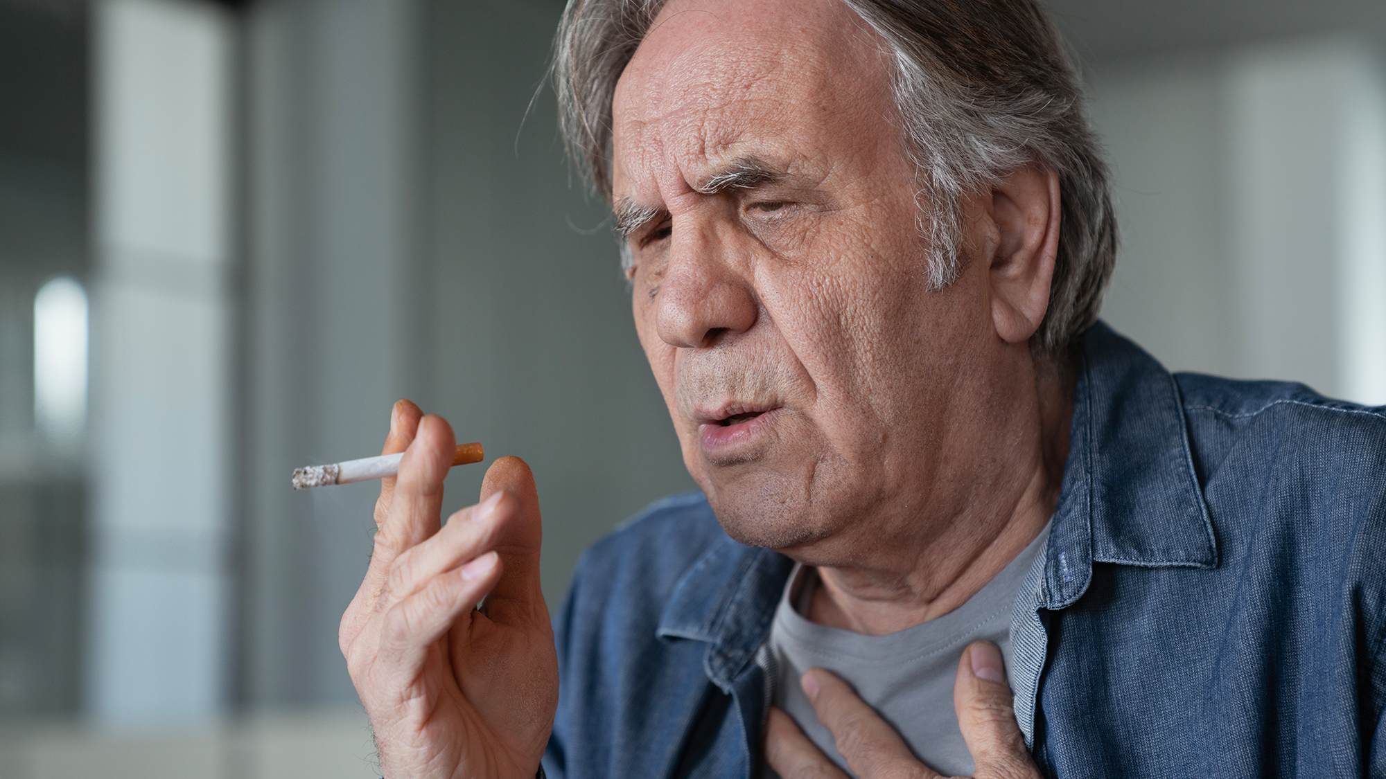 older man smoking a cigarette