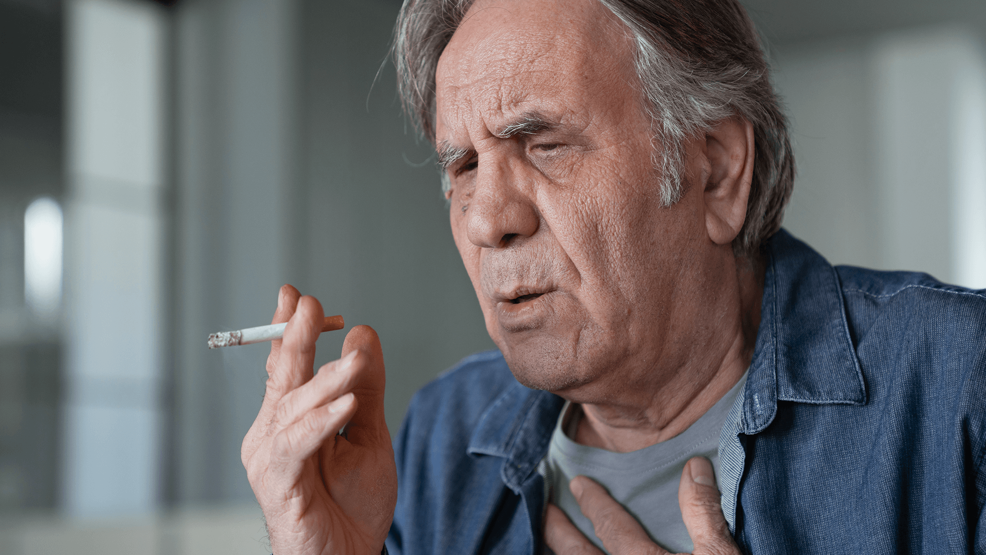 older man smoking a cigarette