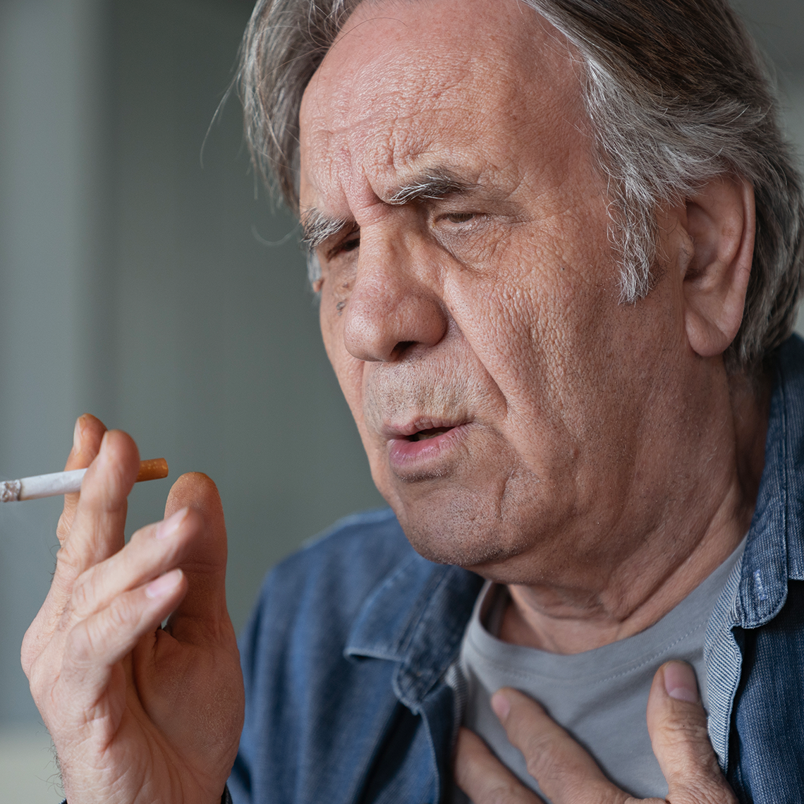 older man smoking a cigarette