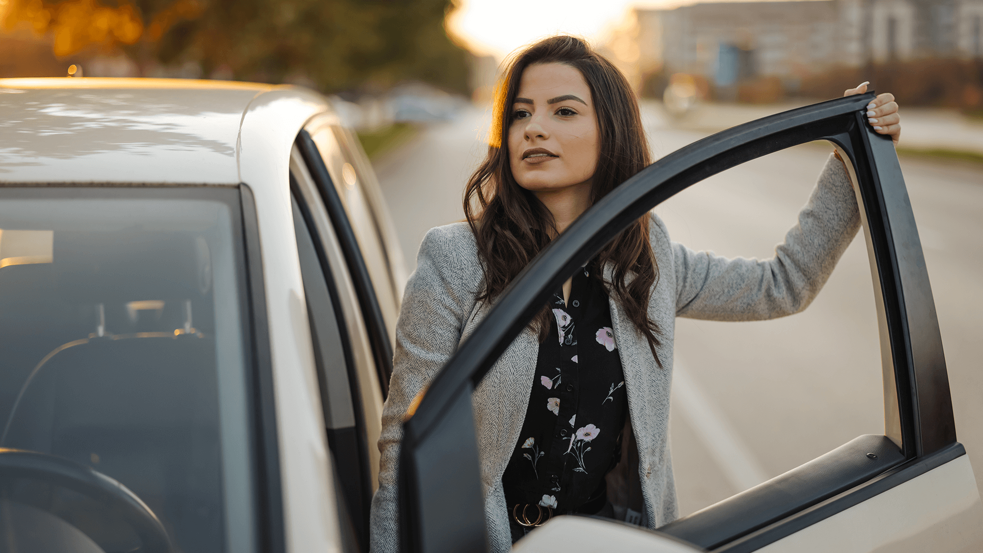 Woman entering or exiting a car