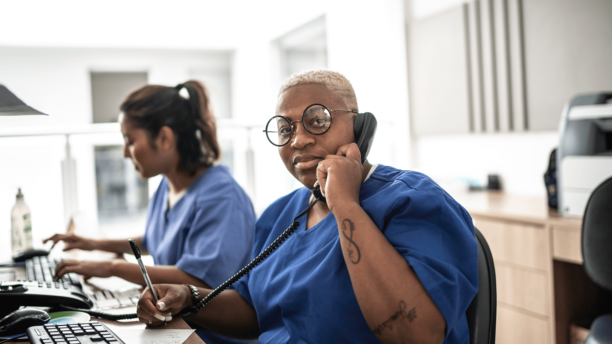 Nurse at computer on the phone