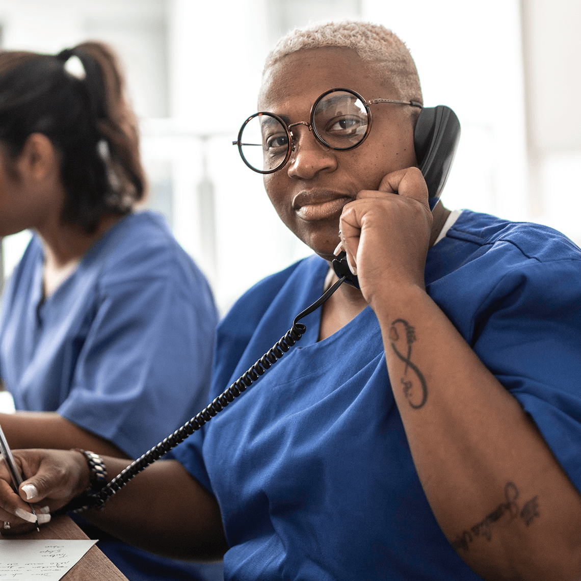 Nurse at computer on the phone