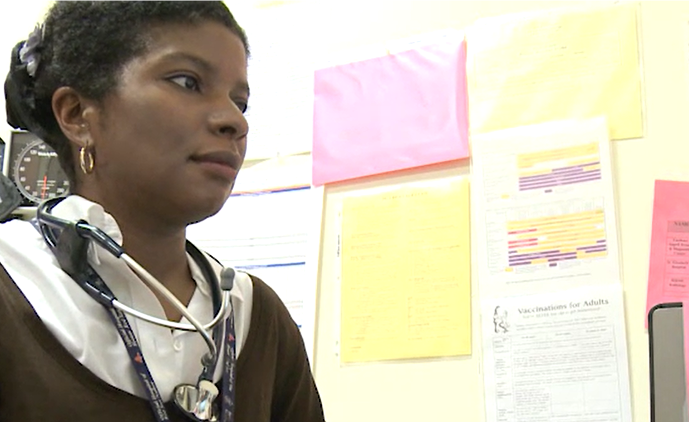 African American Woman typing in Clinical Notes in Office